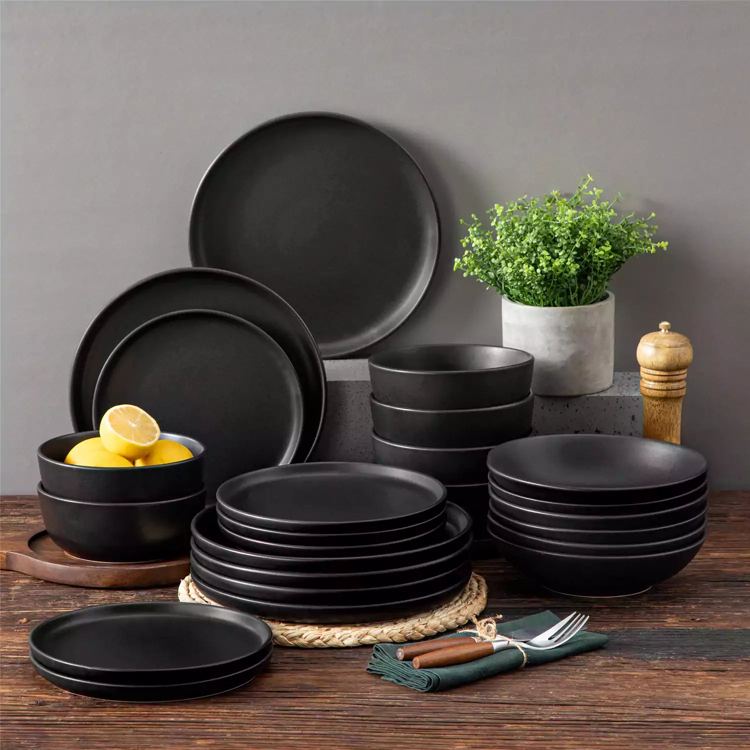A matte black 24-piece stoneware dinnerware set from the Playa collection by vancasso - adding a modern flair with plates and bowls for 6 people