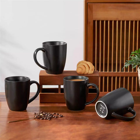 Playa 16oz stoneware mug in black on a rustic wooden kitchen table for a modern breakfast with coffee and fresh fruit