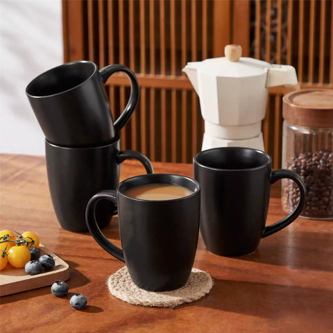 Playa 16oz stoneware mug in black on a rustic wooden kitchen table for a modern breakfast with coffee and fresh fruit