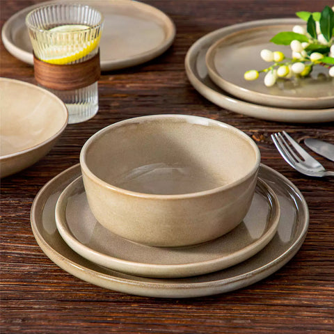 A glossy brown 16-piece stoneware dinnerware set from the Playa collection - featuring farmhouse charm with plates and bowls for 4 people-vancasso