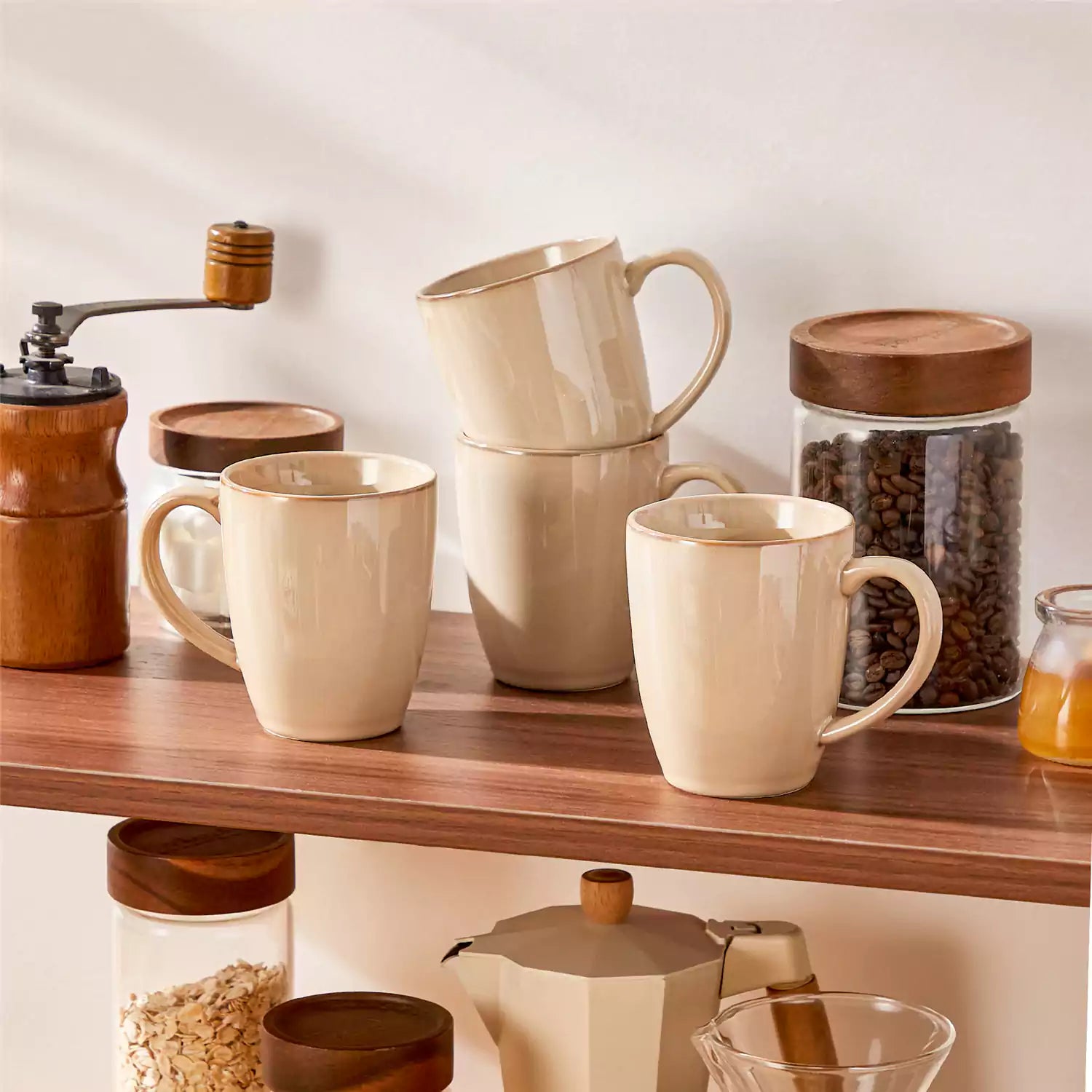 Playa set of four brown reactive glaze stoneware mugs on a wooden tray with a flat white and black coffee beside fresh croissants and berries