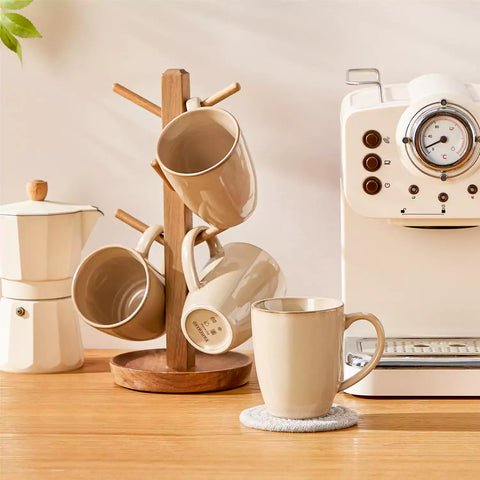 Playa set of four brown reactive glaze stoneware mugs on a wooden tray with a flat white and black coffee beside fresh croissants and berries