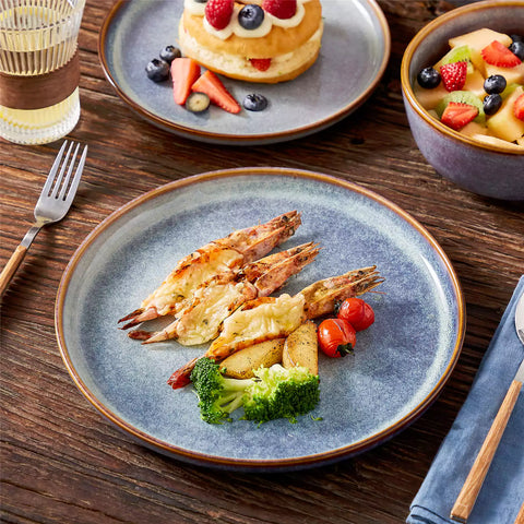A glossy deep indigo 16-piece stoneware dinnerware set from the Playa collection - featuring farmhouse charm with plates and bowls for 4 people-vancasso