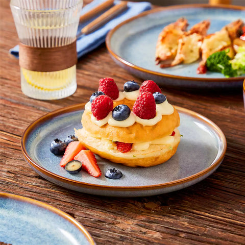 A glossy deep indigo 16-piece stoneware dinnerware set from the Playa collection - featuring farmhouse charm with plates and bowls for 4 people-vancasso