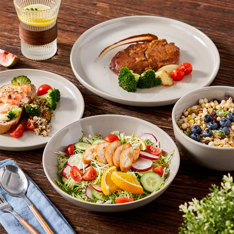 A glossy grey 16-piece stoneware dinnerware set from the Playa collection - featuring farmhouse charm with plates and bowls for 4 people-vancasso