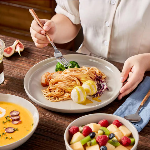 A glossy grey 16-piece stoneware dinnerware set from the Playa collection - featuring farmhouse charm with plates and bowls for 4 people-vancasso