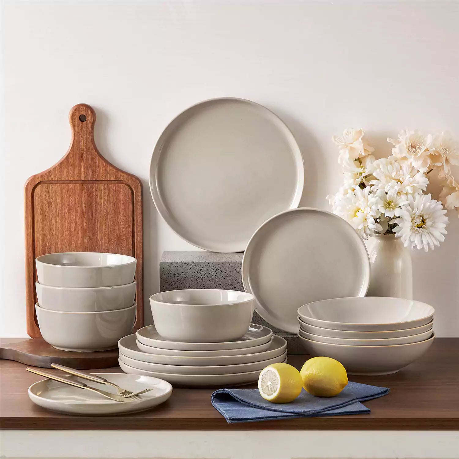 A glossy grey 16-piece stoneware dinnerware set from the Playa collection - featuring farmhouse charm with plates and bowls for 4 people-vancasso
