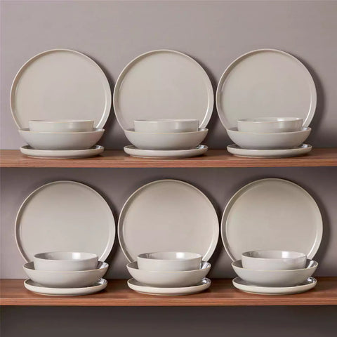 A glossy grey 24-piece stoneware dinnerware set from the Playa collection - featuring farmhouse charm with plates and bowls for 6 people-vancasso