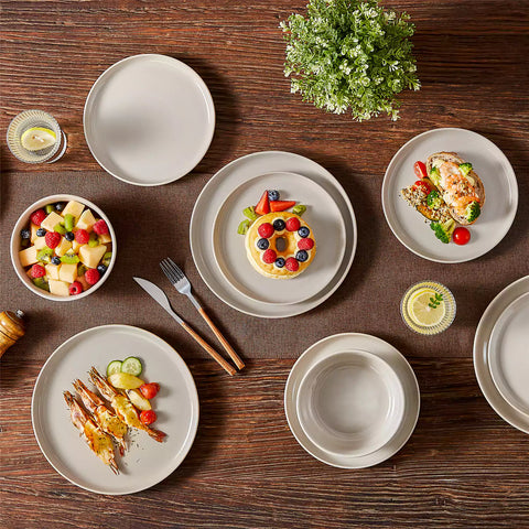 A glossy grey 24-piece stoneware dinnerware set from the Playa collection - featuring farmhouse charm with plates and bowls for 6 people-vancasso