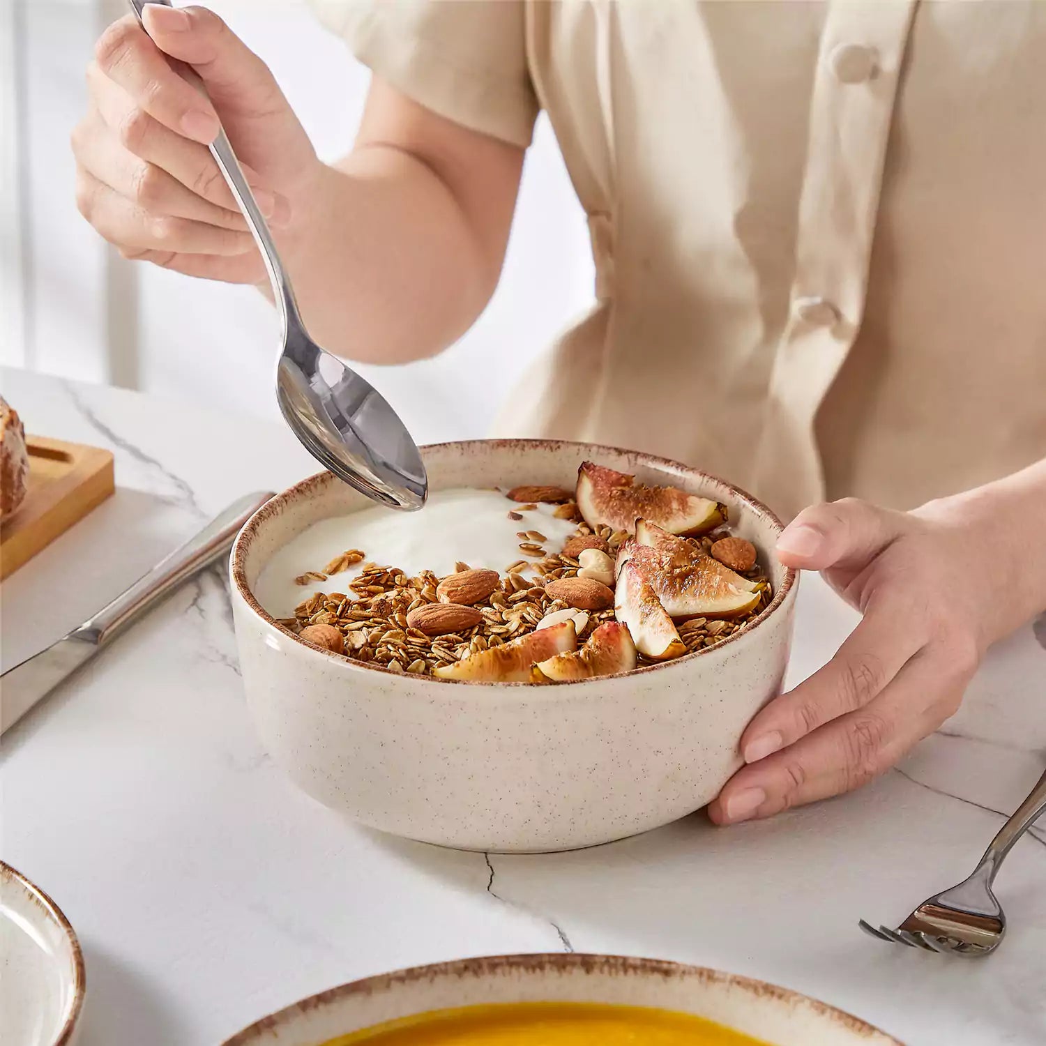 Plays 24-piece stoneware dinnerware set with pasta - soup - and fruit waffle on marble table - featuring sandy speckled plates and bowls with brown rims-vancasso