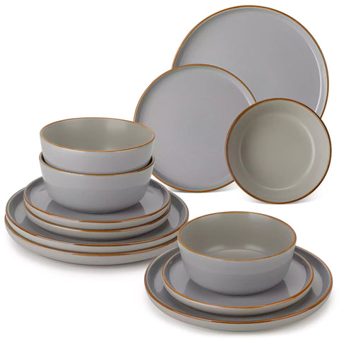 Grey rustic stoneware dinnerware set with speckled - lipped-edge plates and bowls on a dining table with flowers and cutlery in a cozy modern kitchen-vancasso
