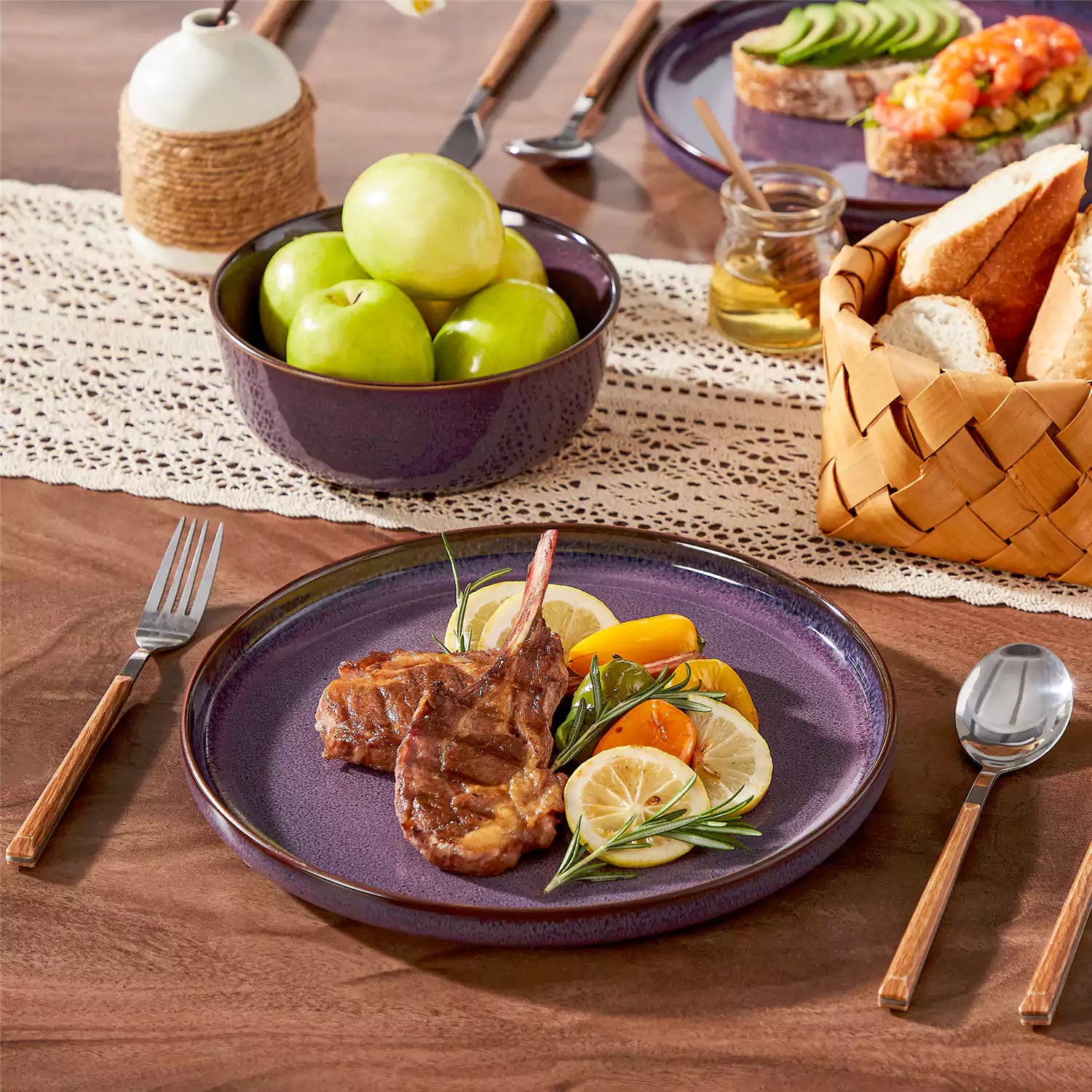 Sata purple stoneware dinner plate set of 4 styled with lamb chops and vegetables on a dinner table farmhouse lipped edge reactive glaze one of a kind finish