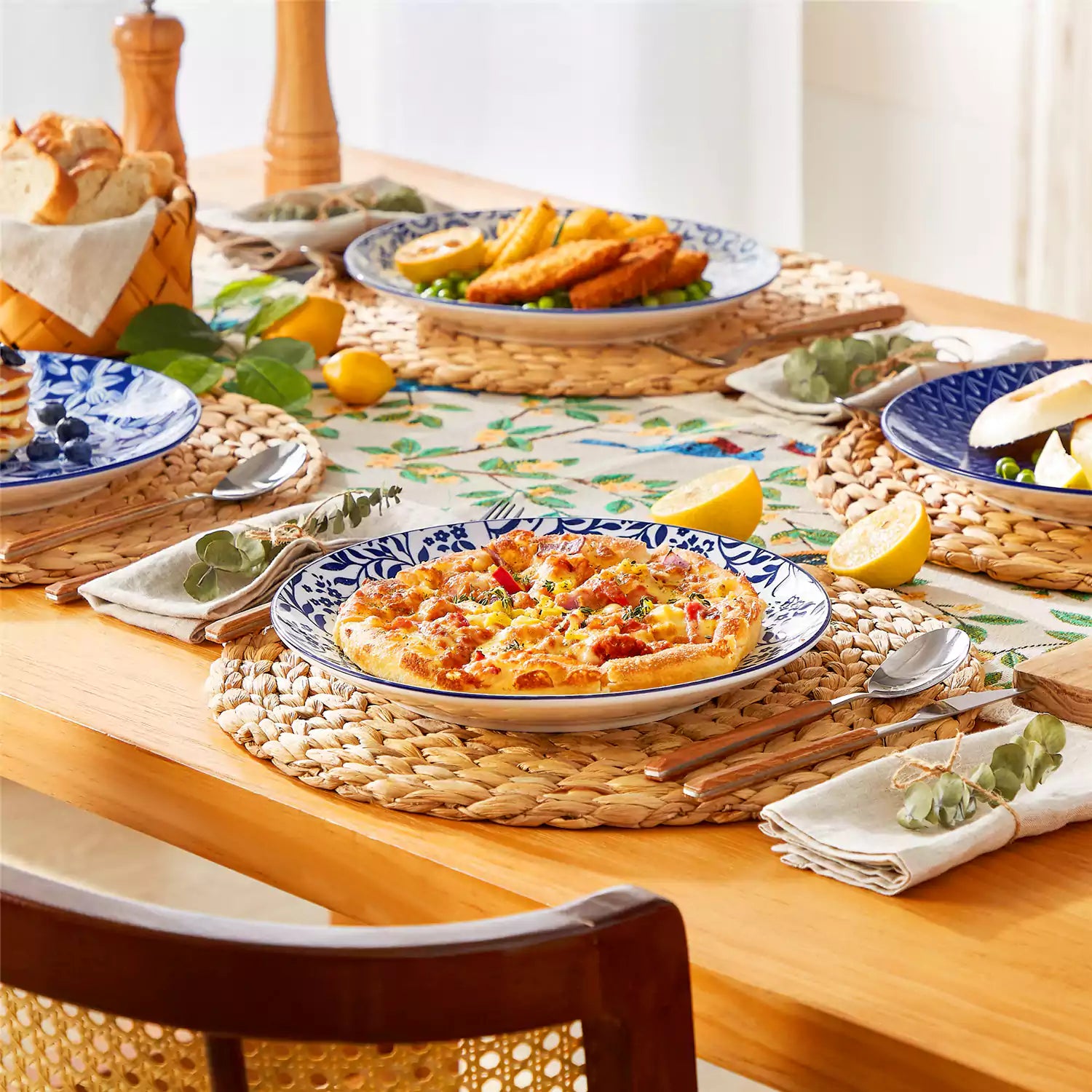 Selene porcelain dinner plates set of 4 styled with pizza and bread on woven placemat mix and match Japanese inspired table setting