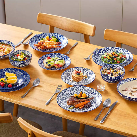 Selene 16-piece porcelain set with indigo floral and geometric patterns on plates - bowls - and mugs displayed on a dining table