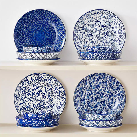 Selene 16-piece porcelain set with indigo floral and geometric patterns on plates - bowls - and mugs displayed on a dining table