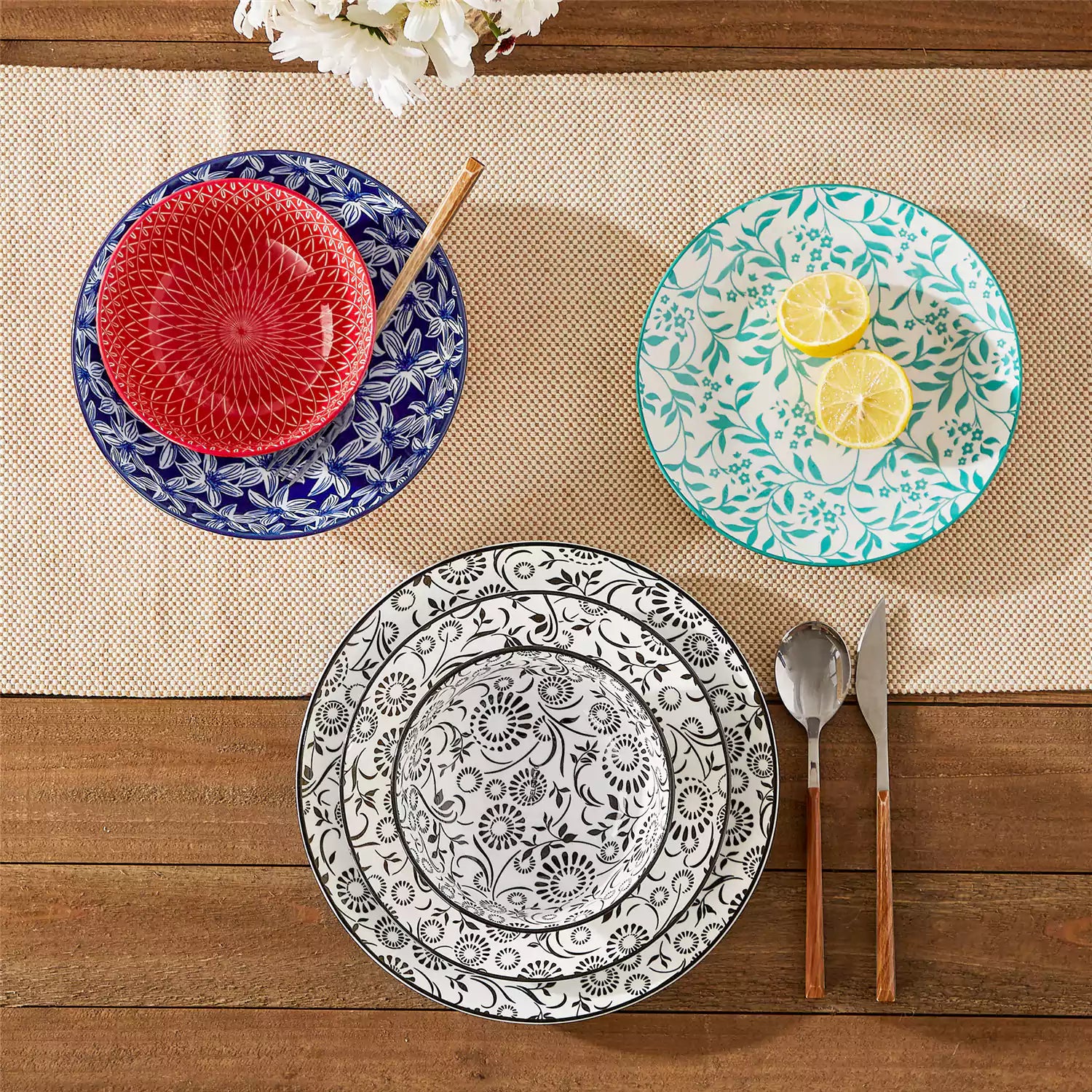 16 piece Japanese porcelain dinnerware set with indigo and earth tone floral geometric patterns on white ceramic plates and bowls