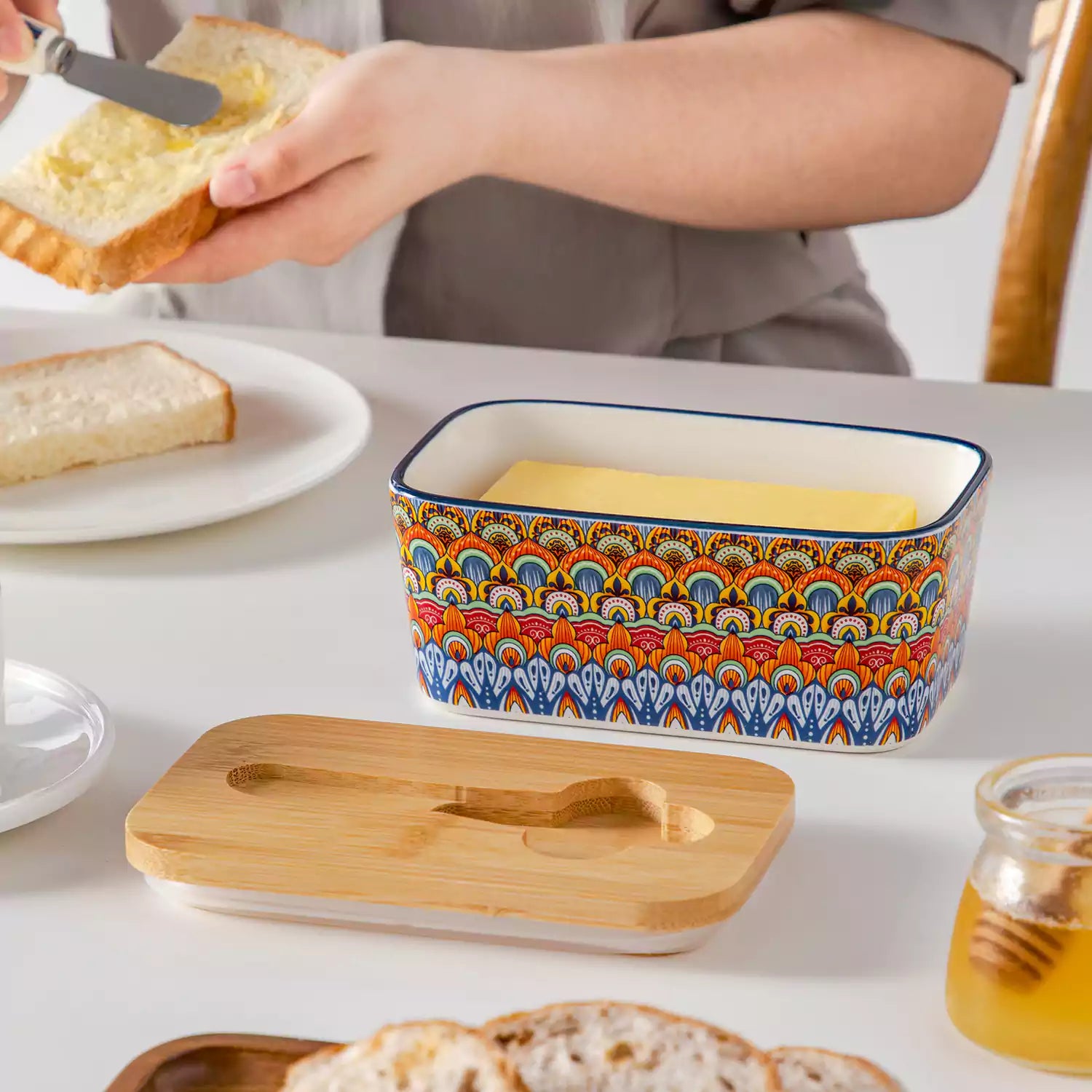 Hunter green porcelain butter dish with wooden lid in boho chic style - perfect for a colorful breakfast table with bread and coffee-vancasso