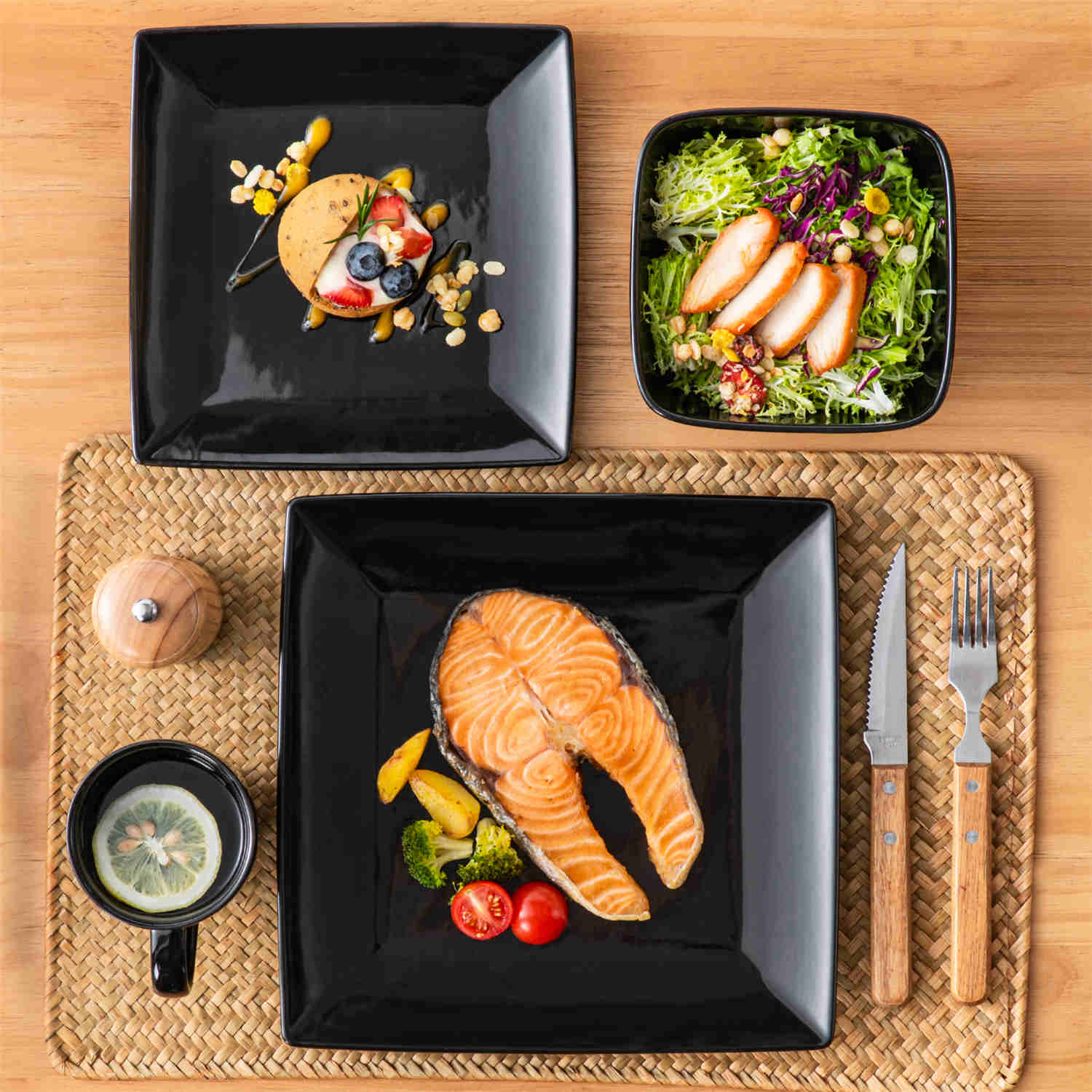 A glossy black 24-piece stoneware dinnerware set from the Soho collection - featuring a sleek square design with plates and mugs for 6 people-vancasso