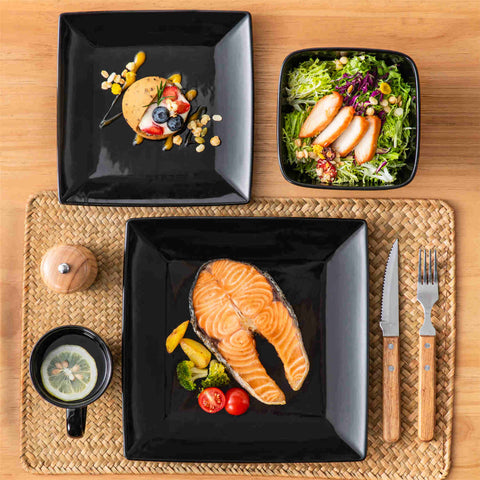 A glossy black 24-piece stoneware dinnerware set from the Soho collection - featuring a sleek square design with plates and mugs for 6 people-vancasso