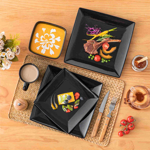 A glossy black 24-piece stoneware dinnerware set from the Soho collection - featuring a sleek square design with plates and mugs for 6 people-vancasso