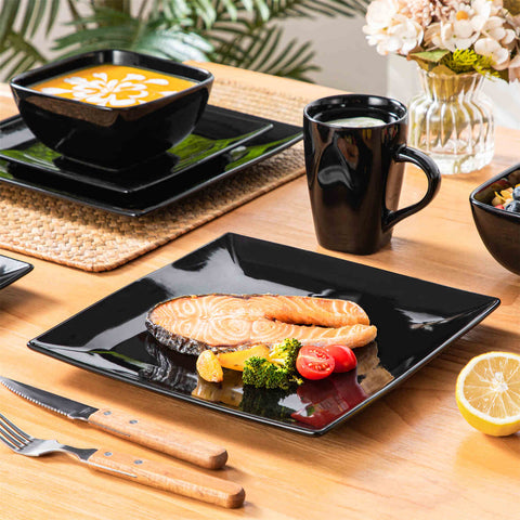 A glossy black 24-piece stoneware dinnerware set from the Soho collection - featuring a sleek square design with plates and mugs for 6 people-vancasso