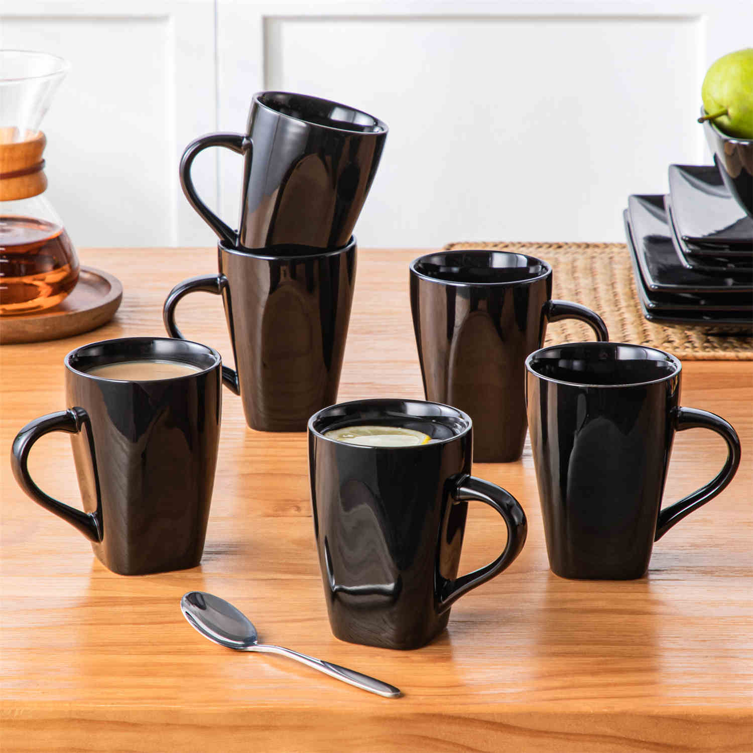 A glossy black 24-piece stoneware dinnerware set from the Soho collection - featuring a sleek square design with plates and mugs for 6 people-vancasso