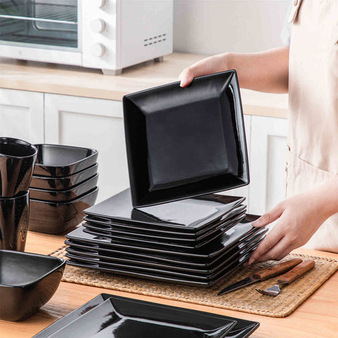 A glossy black 24-piece stoneware dinnerware set from the Soho collection - featuring a sleek square design with plates and mugs for 6 people-vancasso