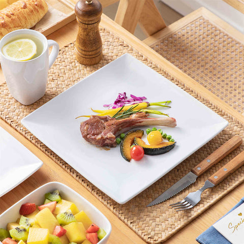 A glossy white 24-piece stoneware dinnerware set from the Soho collection - featuring a sleek square design with plates and mugs for 6 people-vancasso