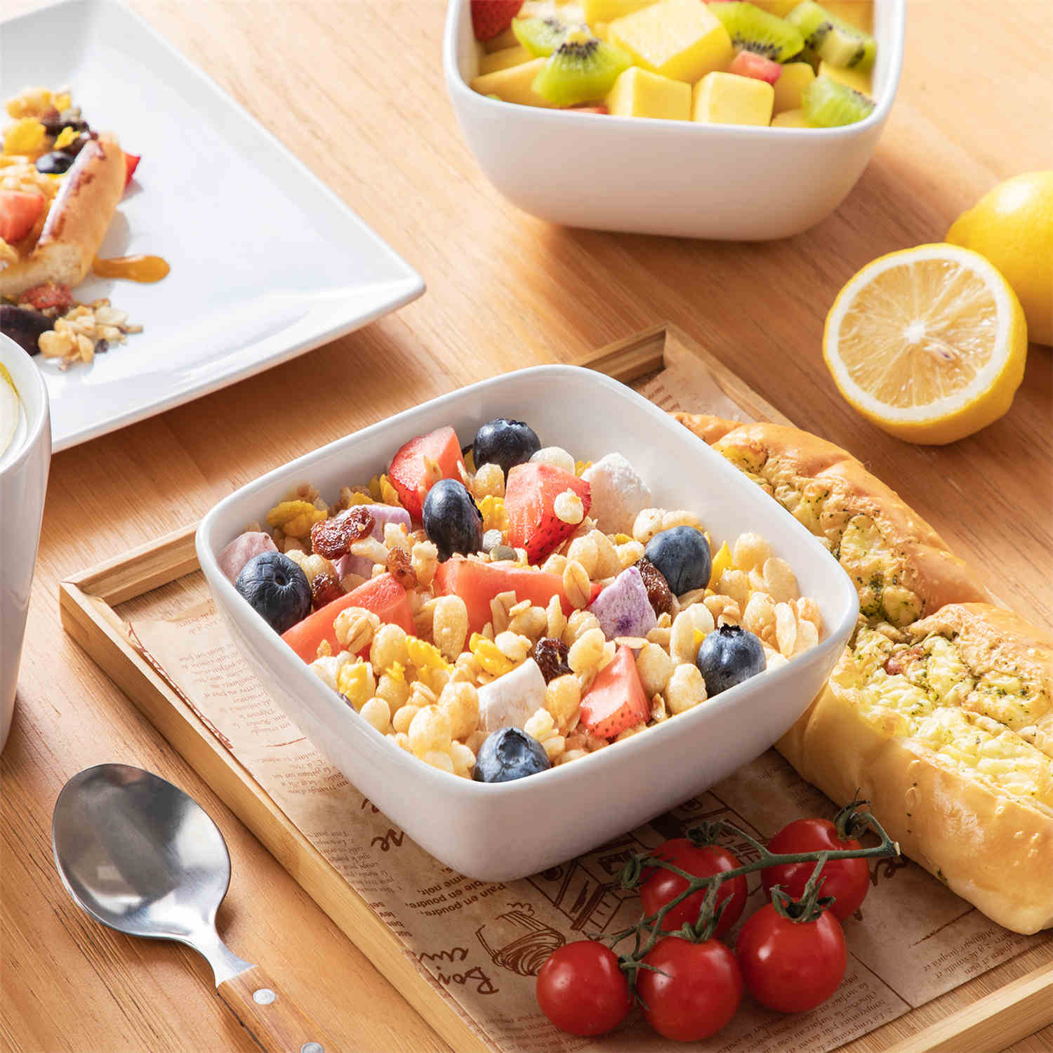 A glossy white 24-piece stoneware dinnerware set from the Soho collection - featuring a sleek square design with plates and mugs for 6 people-vancasso