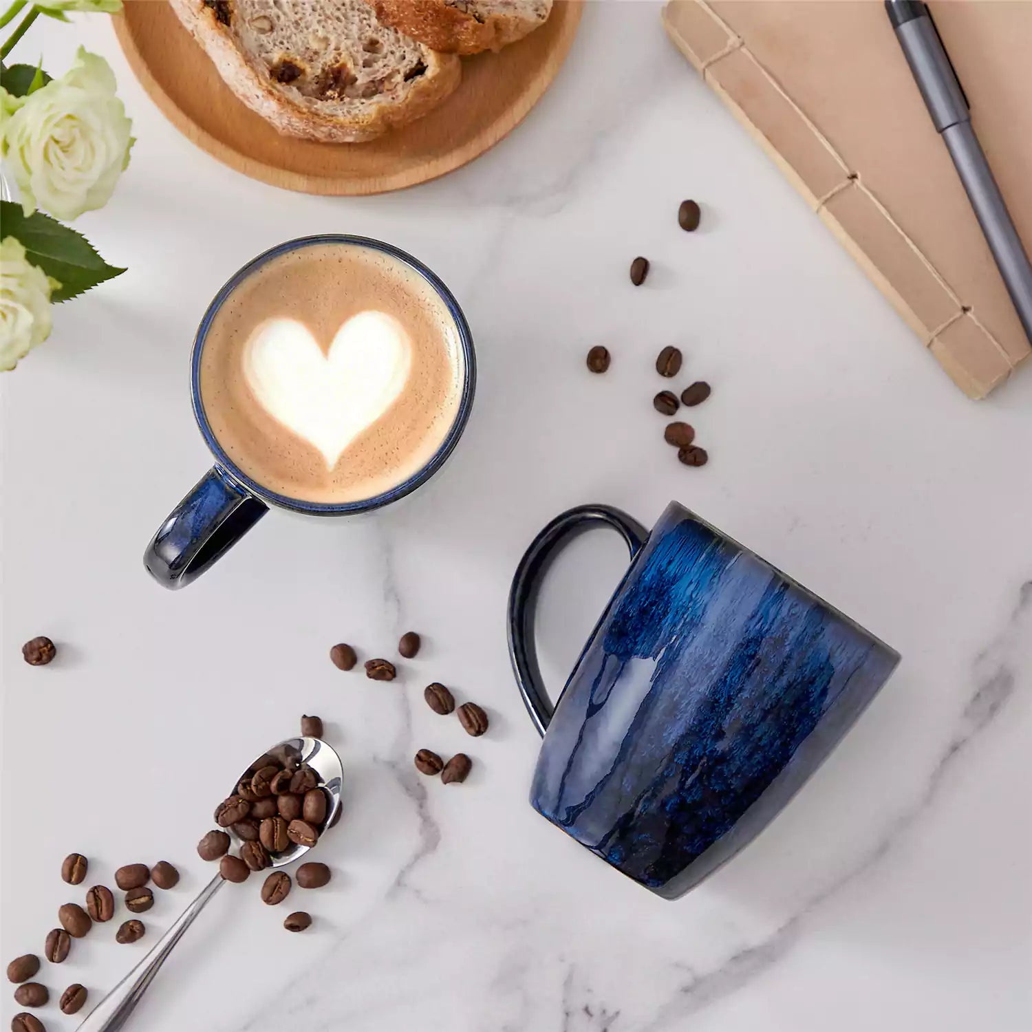 Blue Starry 12oz stoneware mugs set of 4 with reactive glaze finish on a kitchen counter with coffee milk and fresh bread