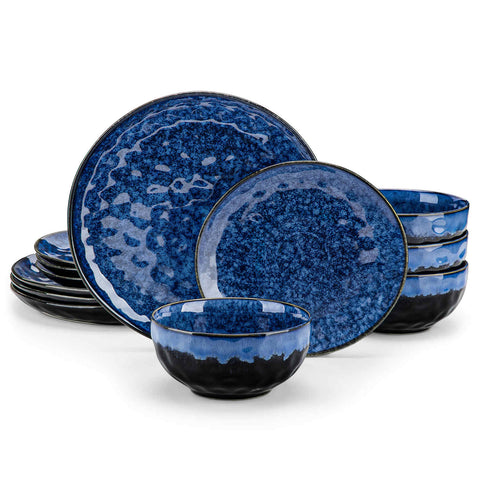 Starry 12-piece stoneware dinnerware set in blue on a light wooden table - styled with lamb chops - pastries - coffee pot - and lemon water for a cozy farmhouse breakfast scene
