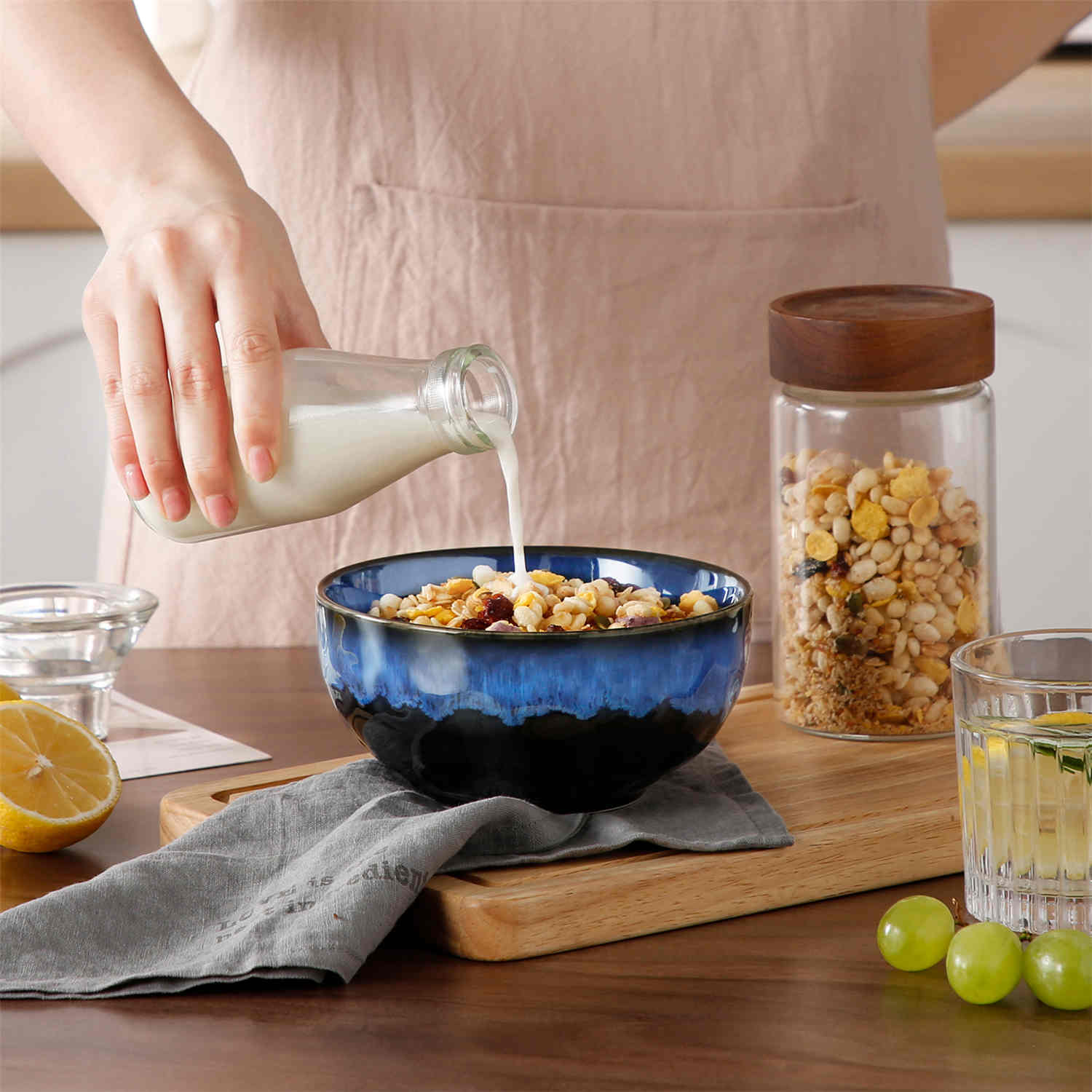Starry reactive glaze cereal bowls in blue on a rustic wooden table - filled with creamy soup - pasta - and fresh fruit salad for a cozy - celestial dining vibe
