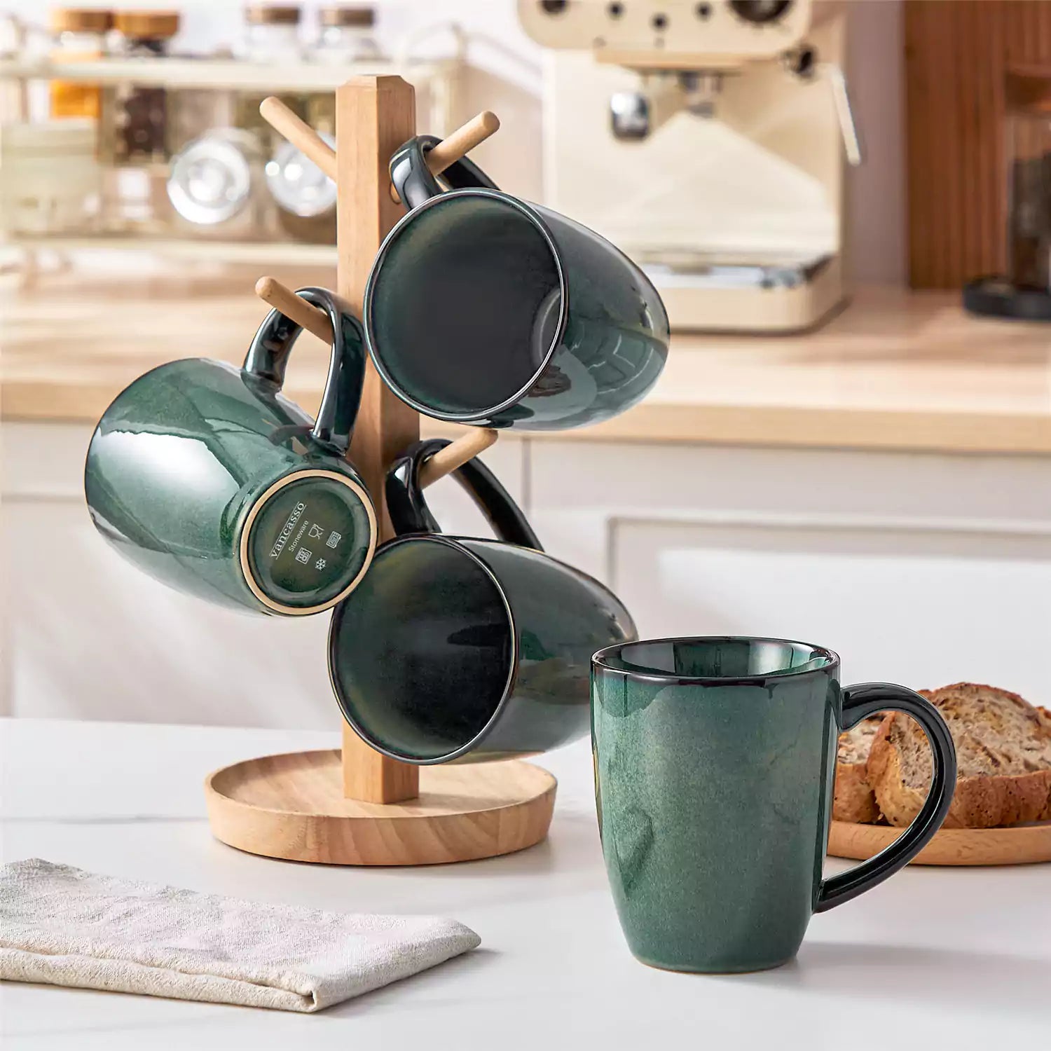 Set of 4 Starry 16oz stoneware mugs in green with reactive glaze finish styled on a marble countertop with fresh coffee