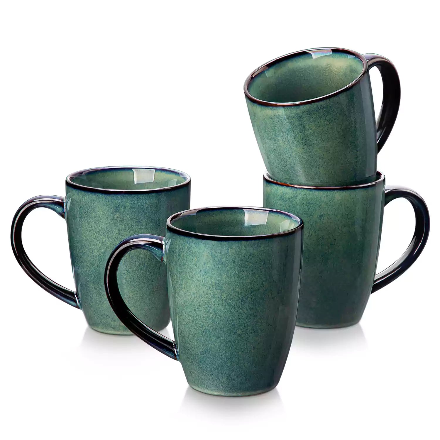 Set of 4 Starry 16oz stoneware mugs in green with reactive glaze finish styled on a marble countertop with fresh coffee