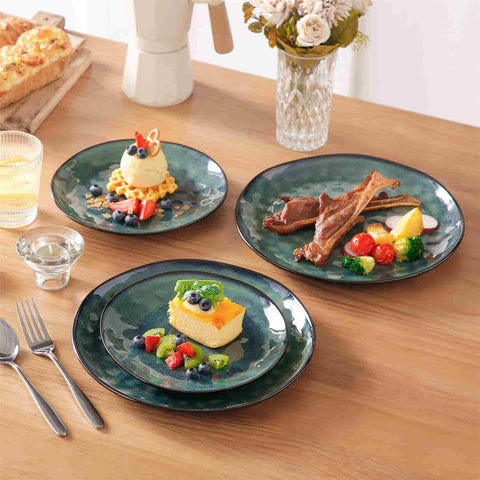 Starry 12-piece stoneware dinnerware set in green on a light wooden table - styled with lamb chops - pastries - coffee pot - and lemon water for a cozy farmhouse breakfast scene