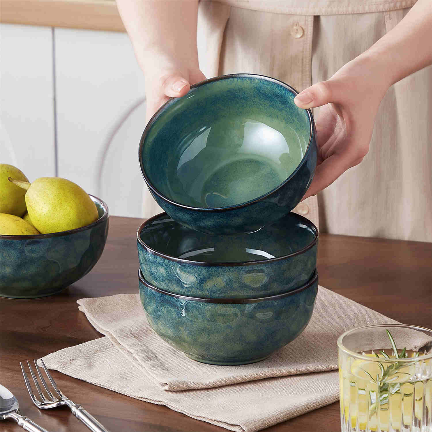 Starry reactive glaze cereal bowls in teal green on a rustic wooden table - filled with creamy soup - pasta - and fresh fruit salad for a cozy - celestial dining vibe