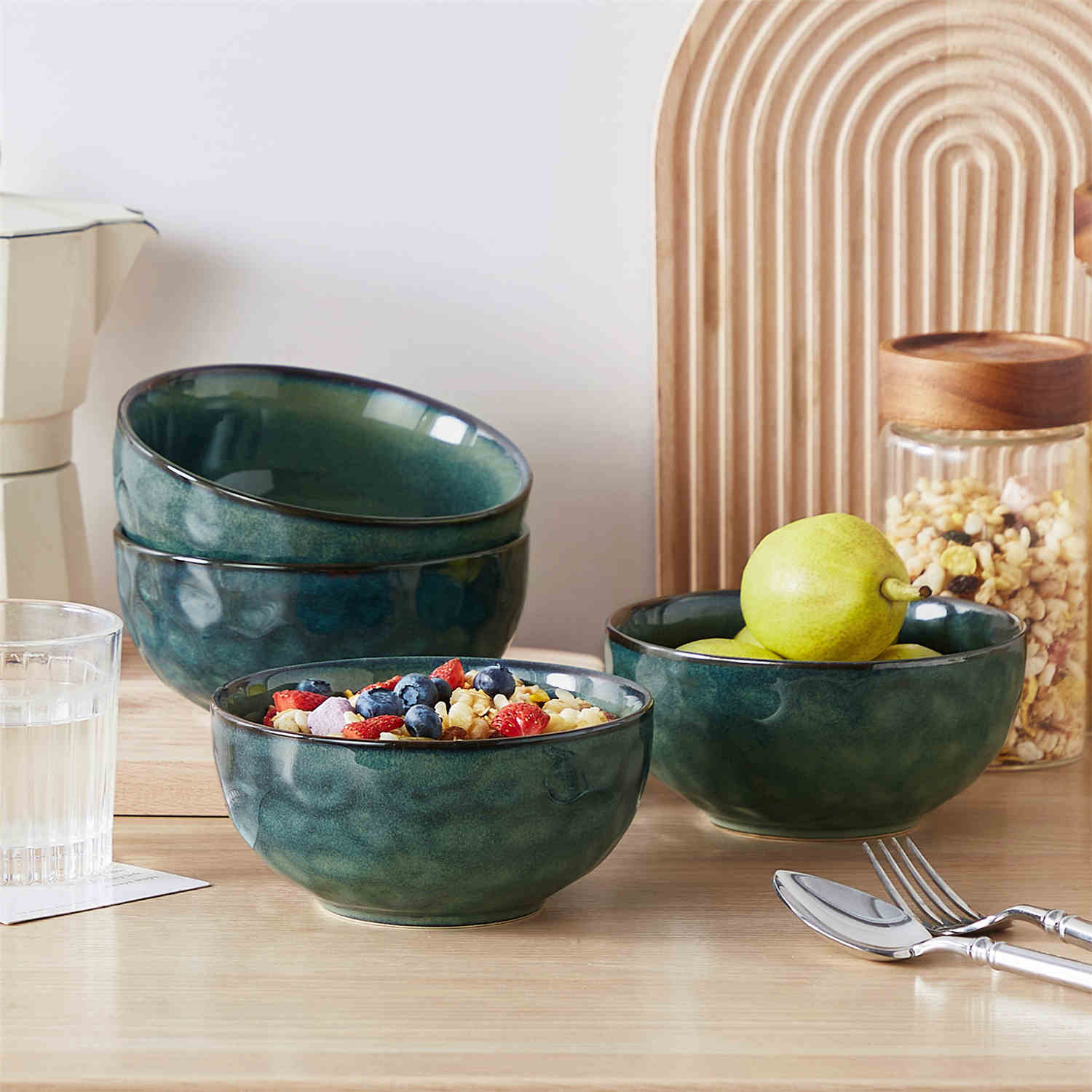 Starry reactive glaze cereal bowls in teal green on a rustic wooden table - filled with creamy soup - pasta - and fresh fruit salad for a cozy - celestial dining vibe