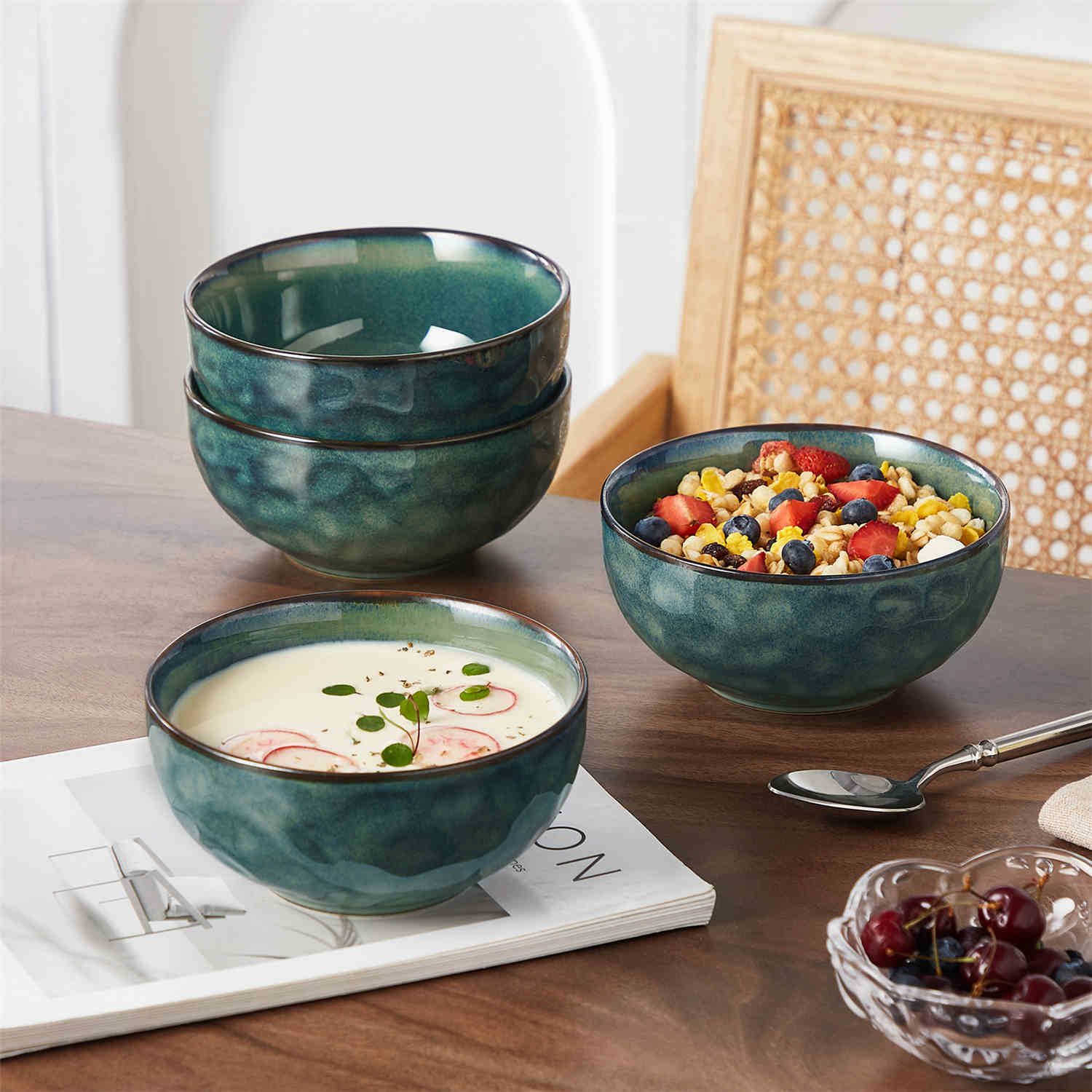 Starry reactive glaze cereal bowls in teal green on a rustic wooden table - filled with creamy soup - pasta - and fresh fruit salad for a cozy - celestial dining vibe