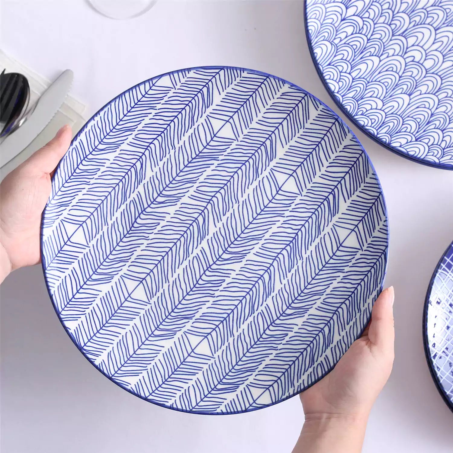 Porcelain dinner plates set of 4 with classic Japanese indigo stripe patterns, featuring assorted designs, ideal for serving steak.